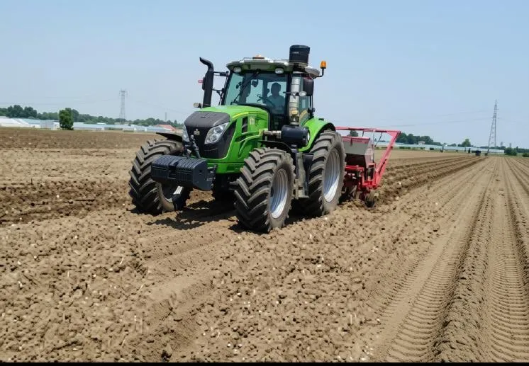 A PHOKA AF2604 tractor drawing a planter across a worked field